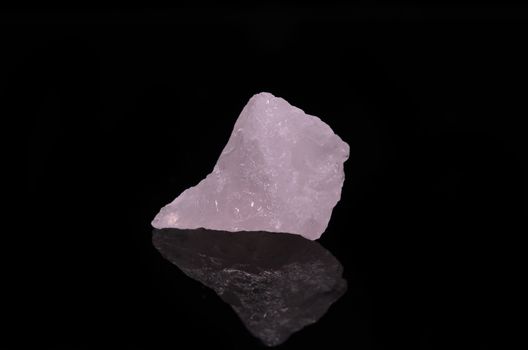 Sample of a beautiful Rose Quartz nature specimen isolated on black background