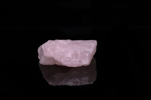 Sample of a beautiful Rose Quartz nature specimen isolated on black background