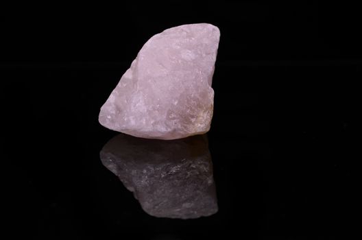 Sample of a beautiful Rose Quartz nature specimen isolated on black background