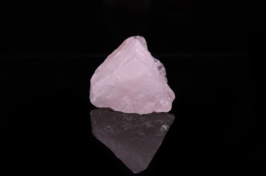 Sample of a beautiful Rose Quartz nature specimen isolated on black background