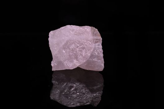 Sample of a beautiful Rose Quartz nature specimen isolated on black background