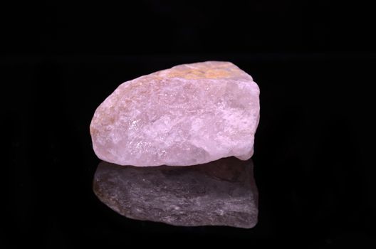 Sample of a beautiful Rose Quartz nature specimen isolated on black background