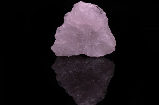 Sample of a beautiful Rose Quartz nature specimen isolated on black background