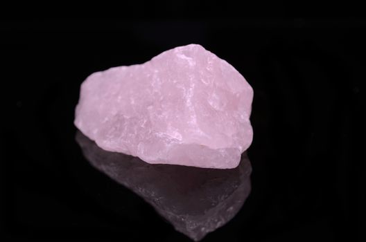 Sample of a beautiful Rose Quartz nature specimen isolated on black background