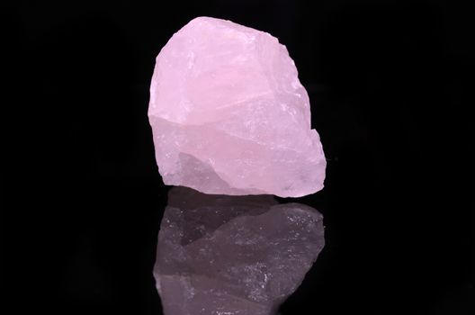 Sample of a beautiful Rose Quartz nature specimen isolated on black background