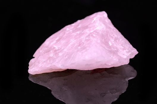 Sample of a beautiful Rose Quartz nature specimen isolated on black background