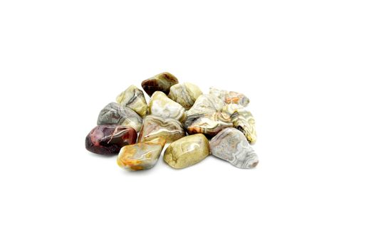 Set of a beautiful tumbled crazy lace agate semiprecious stones isolated on white