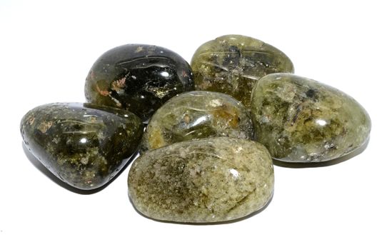 Set of a beautiful tumbled Demantoid - Green Garnet semiprecious stones isolated on white