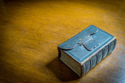 Closed 18th century Bible-Songbook on an old wooden table







Closed Bible-Songbook on a wooden table