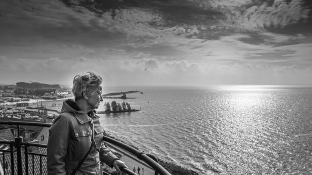 Senior Woman looking at the Storm over the IJselmeer from the lighthouse in the historic fishing village of Urk in the Netherlands in a black and white photo







Senior Woman looking at the Storm over the IJselmeer from the lighthouse in the historic fishing village of Urk in the Netherlands