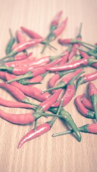 red chili peppers on wood table background vintage style