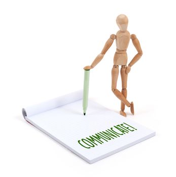 Wooden mannequin writing in a scrapbook - Communicate