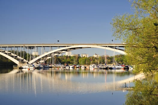 Stockholm bridge. Vasterbron in spring light, with water and trees in March, Stockholm, Sweden.