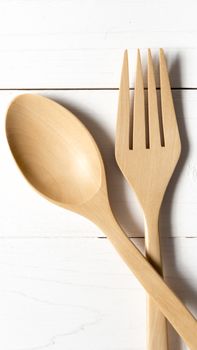 wood spoon and fork over white table background