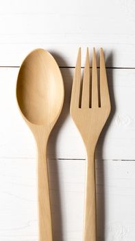 wood spoon and fork over white table background