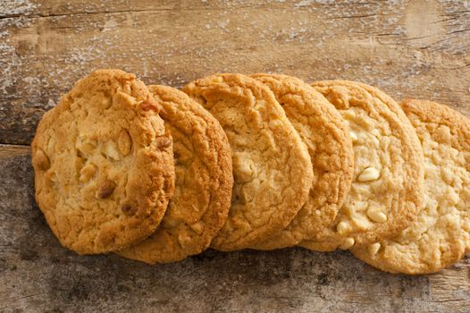 Close up Top View of Fresh Homemade Macadamia Cookies on Rustic Wooden Table