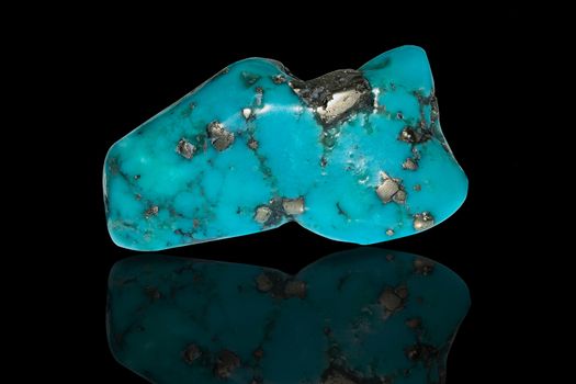 Sample of a beautiful Turquoise tumbled stone specimen isolated on black background