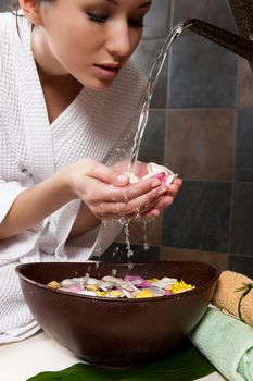 Young attractive woman taking massage and spa procedures