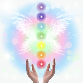 Healing Hands and seven chakras on a sparkling pastel coloured background