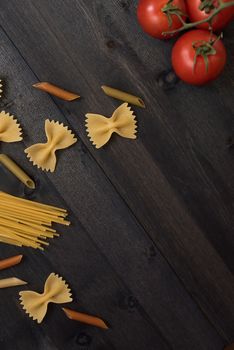 food background on rustic wood with pasta and tomatoes