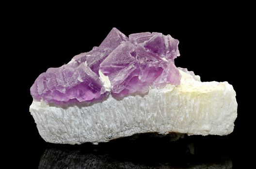 Sample of a beautiful Pink Fluorite nature specimen isolated on black background