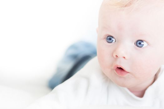 Cute blonde little baby boy with blue eyes.