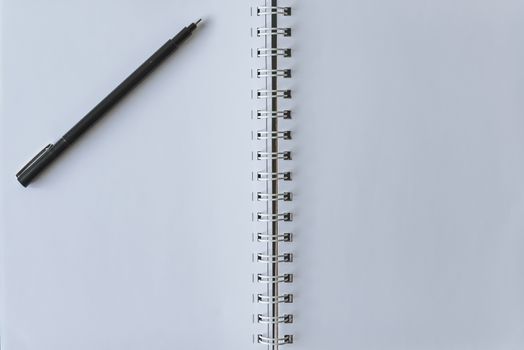 White Notebook blank cover with pen.