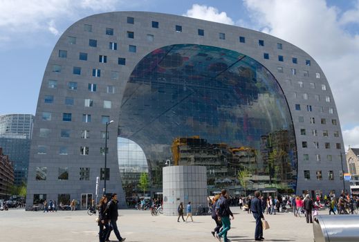 Rotterdam, Netherlands - May 9, 2015: People visit Markthal (Market hall) a new icon in Rotterdam. The covered food market and housing development shaped like a giant arch by Dutch architects MVRDV.