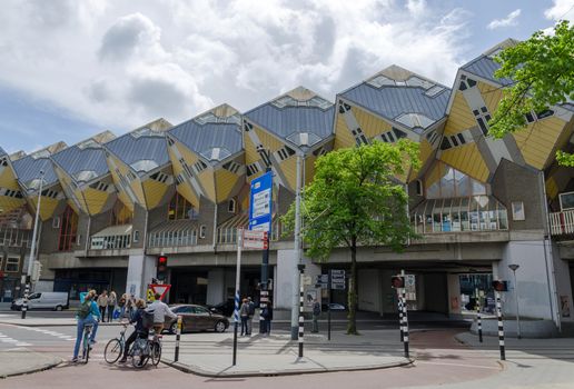 Rotterdam, Netherlands - May 9, 2015: Tourist visit Cube Houses the iconic in the center of the city. Cube Houses are a set of innovative houses built in Rotterdam and Helmond in the Netherlands, designed by architect Piet Blom.