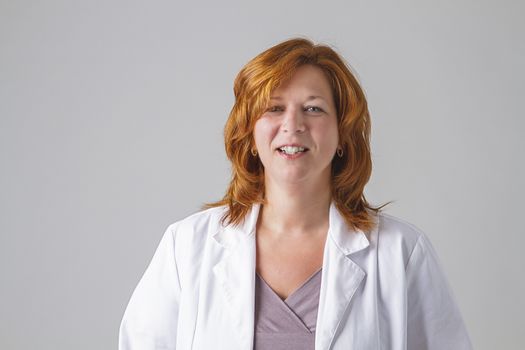 woman in her forties wearing a white lab coat