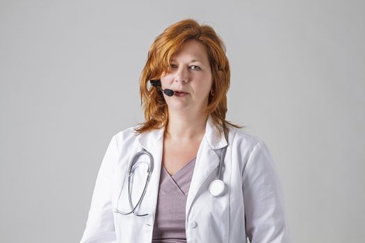 doctor in her forties with a stethoscope and headset