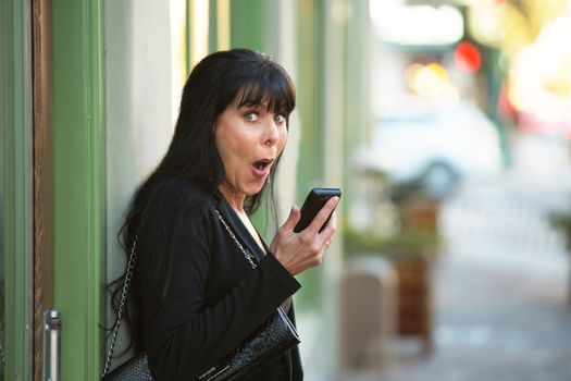 Attractive woman with cellphone on downtown street