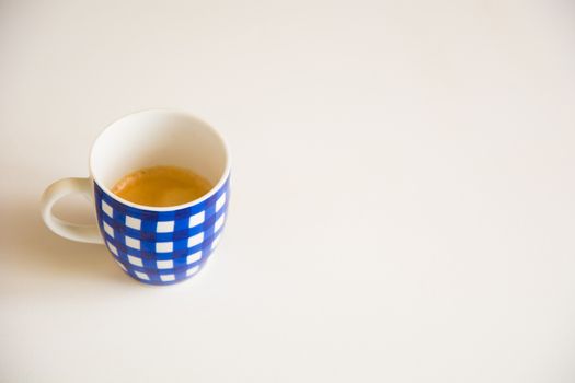 a blue striped cup of coffee