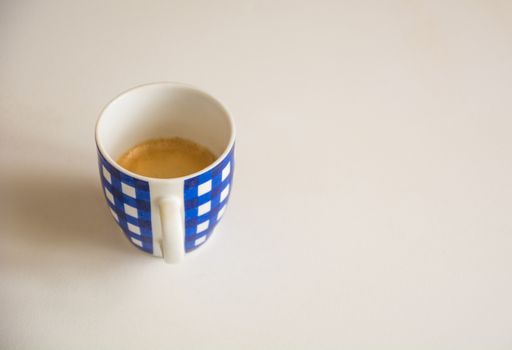 a blue striped cup of coffee