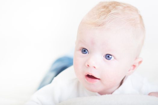 Cute blonde little baby boy with blue eyes.