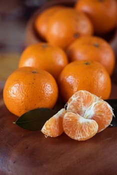 Ripe tangerines on wooden background