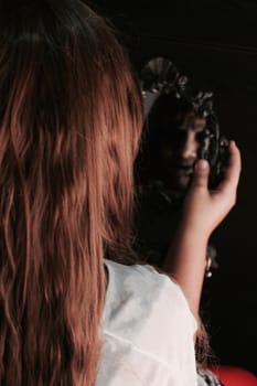 a girl staring at the mirror but her reflection is horrifying.