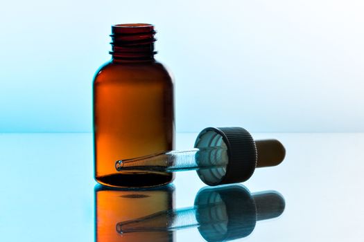 Glass pipette with a brown bottle for medicine