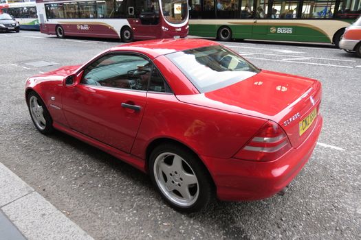 EDINBURGH, UK - CIRCA AUGUST 2015: red Mercedes-Benz SLK230 parked on a street in the city centre