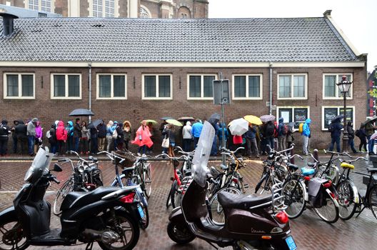 Amsterdam, Netherlands - May 16, 2015: People queuing at the Anne Frank house and holocaust museum in Amsterdam, Netherlands, on May 16, 2015. Anne Frank house is a popular tourist destination.