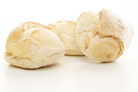 Three fresh white bread over a white background.