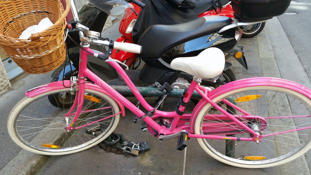 Pink bicycle standing on the street in Lyon, France