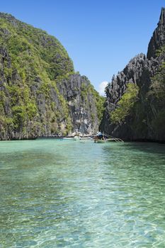  El Nido, Philippines  - May 18, 2014: Island hopping with traditional banca boat in El Nido , Palawan - Philippines . Island hopping is popular activity of tourists visiting Palawan. EL NIDO, PHILIPPINES - MAY 18, 2014: Island hopping with traditional banca boat in El Nido , Palawan on May 18.  Island hopping is popular activity of tourists visiting Palawan.