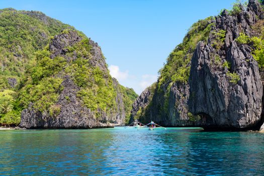  El Nido, Philippines  - May 22, 2014: Island hopping with traditional banca boat in El Nido , Palawan - Philippines . Island hopping is popular activity of tourists visiting Palawan. EL NIDO, PHILIPPINES - MAY 22, 2014: Island hopping with traditional banca boat in El Nido , Palawan on May 22.  Island hopping is popular activity of tourists visiting Palawan.