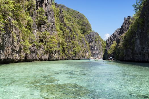  El Nido, Philippines  - May 18, 2014: Island hopping with traditional banca boat in El Nido , Palawan - Philippines . Island hopping is popular activity of tourists visiting Palawan. EL NIDO, PHILIPPINES - MAY 18, 2014: Island hopping with traditional banca boat in El Nido , Palawan on May 18.  Island hopping is popular activity of tourists visiting Palawan.