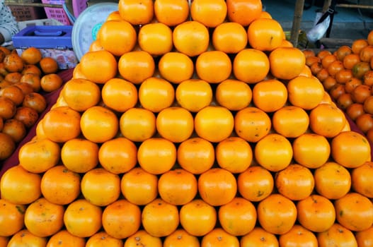 Fresh Oranges background,Orange honeysuckle species, stack on the market for sale.