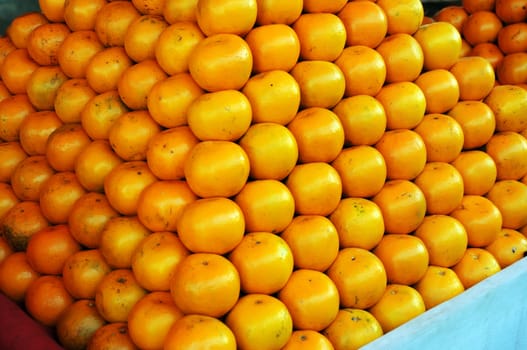 Fresh Oranges background,Orange honeysuckle species, stack on the market for sale.