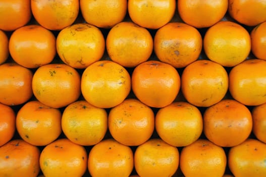 Fresh Oranges background,Orange honeysuckle species, stack on the market for sale.