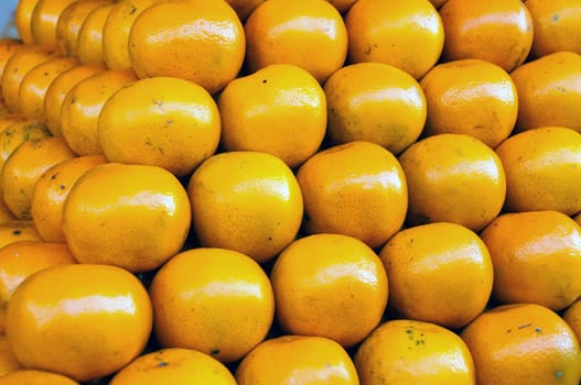 Fresh Oranges background,Orange honeysuckle species, stack on the market for sale.