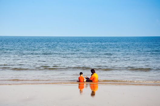 Happy Young Family Having Fun on Beach